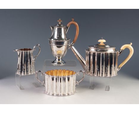 AN EDWARDIAN ELKINGTON AND CO., ELECTROPLATED THREE PIECE TEA SERVICE of fluted oval form, the TEAPOT, with ivory handle and 