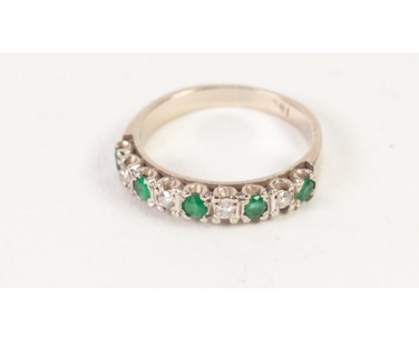 AN 18ct WHITE GOLD TINY DIAMOND AND EMERALD SET HALF HOOP RING, 3.7gms gross