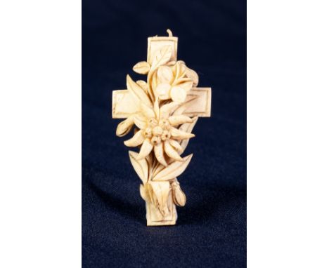 NINETEENTH CENTURY EUROPEAN CARVED IVORY CROSS PENDANT, with an Edelweiss in free relief, 2 3/4" high (ring hanger missing) 