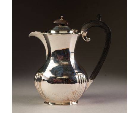 EARLY 20th CENTURY SILVER COFFEE POT of panelled baluster form with narrow gadrooned rim, black wood handle and finial, Birmi