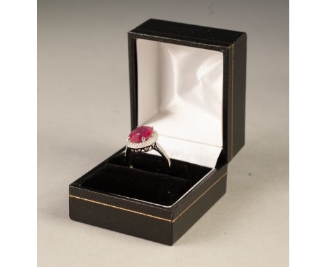 14ct WHITE GOLD, RUBY AND DIAMOND CLUSTER RING, set with an oval cut ruby, approx 5.20ct, with a two tier surround of numerou