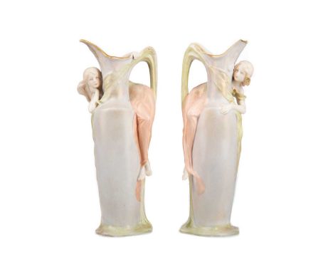 PAIR OF CONTINENTAL SECESSIONIST CERAMIC EWERS,late 19th / early 20th century, likely Bohemia, mounted with moulded reclining
