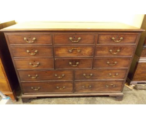 GEORGE III LANCASHIRE MAHOGANY CHEST OF THIRTEEN DRAWERS ON BRACKET FEET