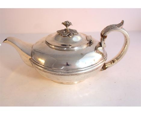 A Georgian Silver tea pot marks for London 1831, Thomas Mitchell, finely cast with rose finial. Weight 586grams