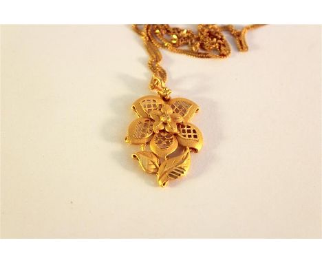 A 21k yellow gold Saudi Arabian Pendant on fine chain. The pendant cast as flower with pierced petals and textured polished f
