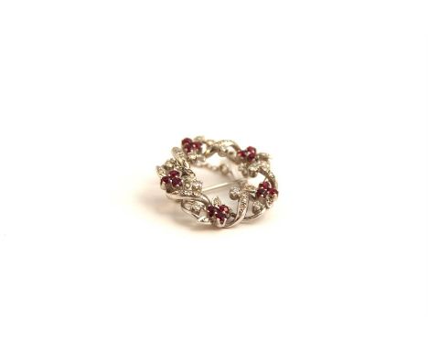 18ct White gold, diamond and ruby mounted floral brooch. Approx 7.7grams