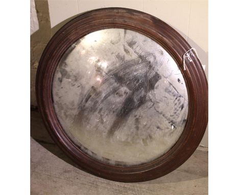 A late 19thC convex mirror with original oak frame. Back not originalApprox 44cms diameter.
