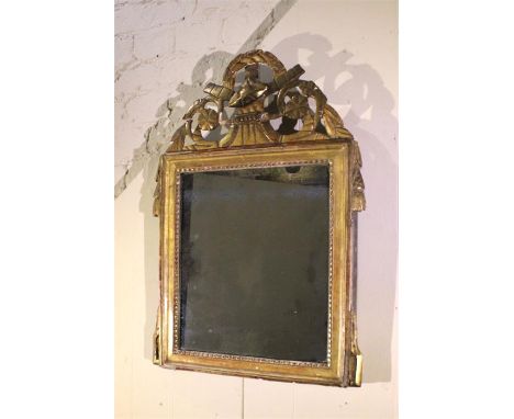 An 18th Century carved gilt mirror retaining original plate. 61cm X 38cm