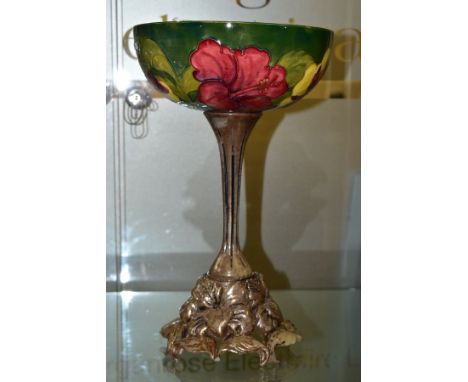 A MOORCROFT POTTERY BOWL DECORATED WITH RED AND YELLOW HIBISCUS ON A GREEN GROUND, the interior of the bowl with a shaded gre