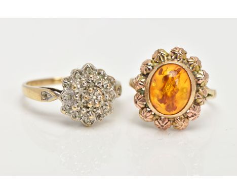 AN AMBER DRESS RING AND A DIAMOND CLUSTER RING, an oval amber cabochon collet set within an outer floral surround, bifurcated