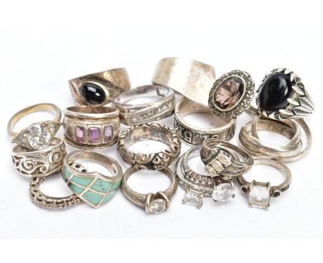A SELECTION OF WHITE METAL RINGS, eighteen rings in total, of various styles and designs, fourteen stamped 925, a cluster rin