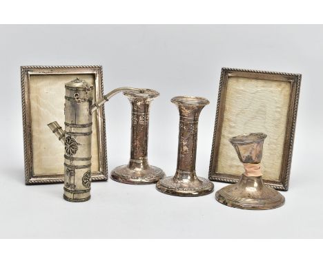 A SELECTION OF SILVER AND WHITE METAL ITEMS, to include a pair of embossed candlesticks, decorated with bows, on round weight