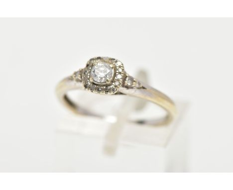 A WHITE METAL DIAMOND RING, the ring head of a square design set with a central round brilliant cut diamond, in a surround of