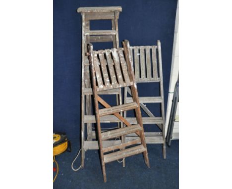 THREE VINTAGE WOODEN STEP LADDERS at 155cm , 135cm and 135cm long