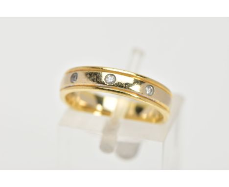 AN 18CT GOLD DIAMOND BAND RING, a yellow gold band with two diamond cut lines to the edges, flush set with three round brilli