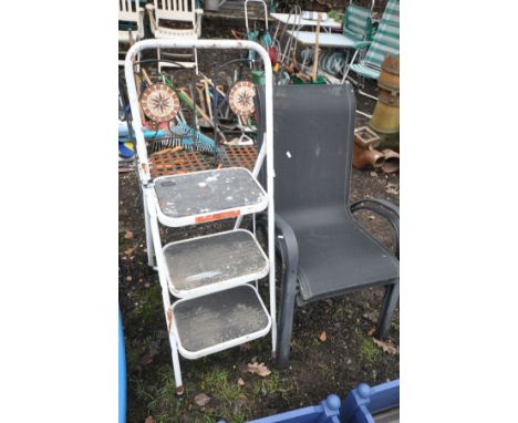 TWO WROUGHT IRON TILE BACK FOLDING GARDEN CHAIRS, along with two stacking garden armchairs and a folding step ladder (5)