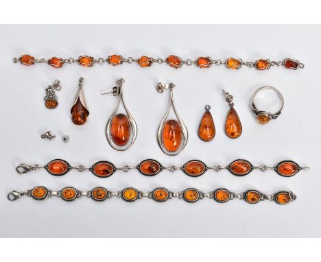 A SELECTION OF AMBER SET JEWELLERY, to include two white metal bracelets set with amber cabochons, fitted with lobster claw c
