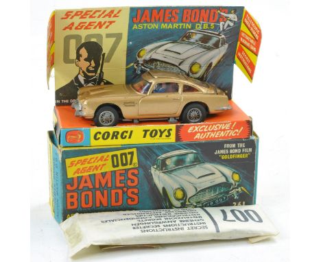 Corgi No. 261 James Bond 007 Aston Martin DB5. Gold with red interior, inc figures. Generally very good, some minor rubs and 