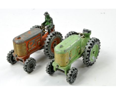 Condor duo of vintage clockwork tractor issues, green and orange examples. Generally fair to good, with obvious signs of age 