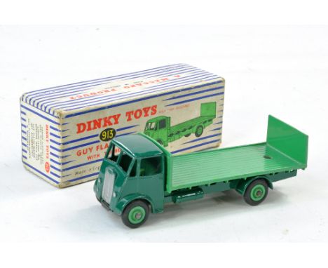 Dinky No. 913 Guy Flat Truck with Tailboard. Dark green cab, chassis and lighter mid green&nbsp;back. Generally very good to 