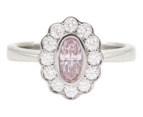 Platinum oval cut fancy pink diamond and round brilliant cut diamond cluster ring, hallmarked, the central pink diamond with 