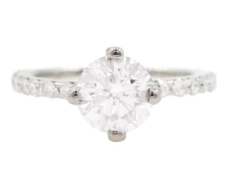 Platinum single stone round brilliant cut diamond ring, with diamond set shoulders and diamond set gallery, principal diamond