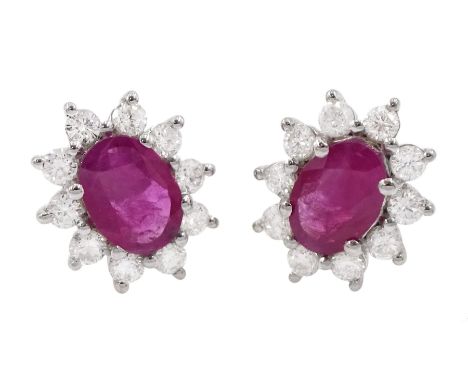 Pair of 18ct white gold oval ruby and round brilliant cut diamond cluster stud earrings, stamped, total ruby weight approx 1.