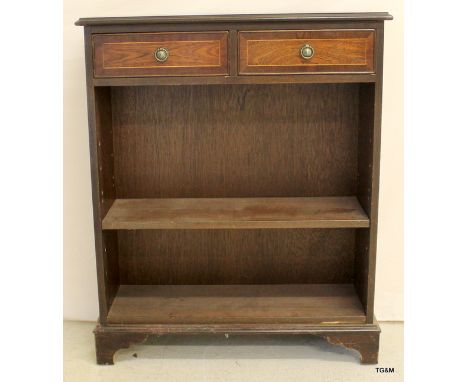 A reproduction bookcase with one shelf and two drawers.