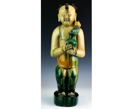 Antique Chinese Sancai Figure  (Chinese, 19th Century or earlier)  Green and Yellow Glazed Statue of A Boy with Potted Lotus 