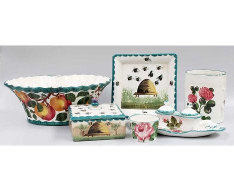 Wemyss Pottery, comprising an ink stand incorporating two inkwells with liners and covers, edged in dark green and painted wi