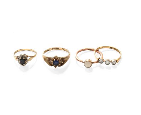 A Diamond Three Stone Ring, stamped '18C', finger size N1/2; Two 9 Carat Gold Cluster Rings, finger sizes H and O (a.f.); and