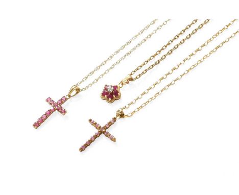 Three Pendants on Chains, comprising of a synthetic ruby and diamond cluster pendant and two cross motif pendantsOne chain st