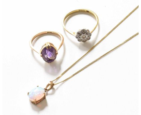 An 18 Carat Gold Diamond Cluster Ring, finger size O; An Amethyst Ring, stamped '9CT', finger size I1/2; and An Opal Pendant 