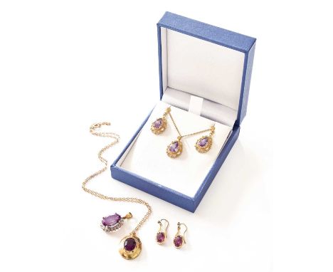 A 9 Carat Gold Amethyst Pendant on Chain and Matching Earrings, the pear cut amethyst in a yellow claw setting, to a filigree