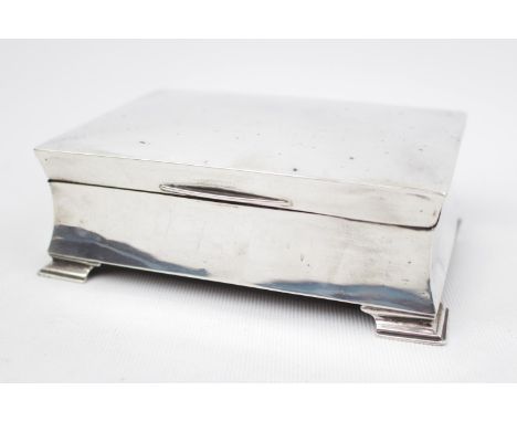 Art Deco Silver cigarette box with concave shaped sides and bracket feet 14cm wide, Birmingham 1923. 400g total weight 