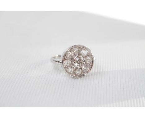 Fine 18ct White Gold Ladies Diamond cluster ring, Central Brilliant Cut Diamond in rub over setting surrounded by a Halo of 8