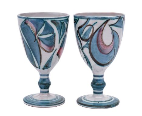 Alan Caiger-Smith [1930-2020] a pair of pottery goblets: decorated with calligraphic designs in blue and pink on an ivory gro