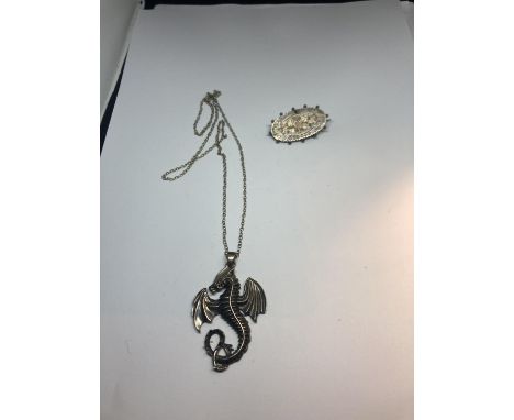 A SILVER NECKLACE WITH AN AMPHIPTERE PENDANT AND A VINTAGE SILVER BROOCH WITH FLORAL DECORATION 