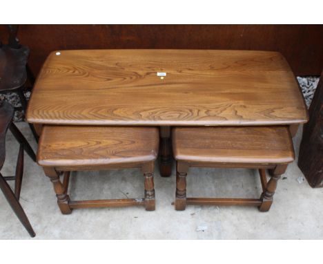 AN ERCOL BLONDE NEST OF THREE TABLES 