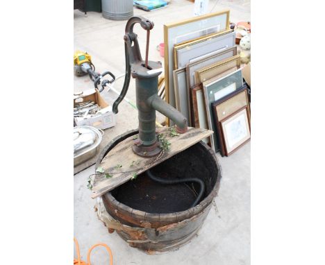 A VINTAGE WOODEN BARREL WATER FEATURE WITH VINTAGE CAST IRON WATER PUMP AND ELECTRIC PUMP 