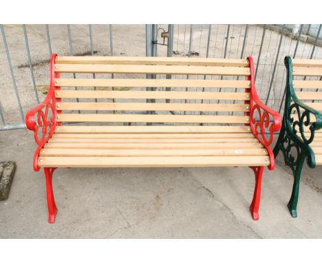 A WOODEN SLATTED GARDEN BENCH WITH DECORATIVE CAST ENDS 