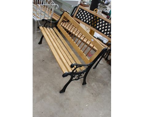 A WOODEN SLATTED GARDEN BENCH WITH CAST BENCH ENDS 