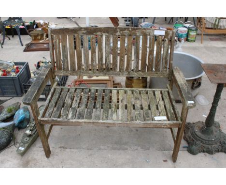 A WOODEN SLATTED GARDEN BENCH 