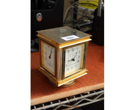 A BRASS JENS OLSEN REVOLVING DESK CLOCK WITH FOUR FACES, TWO BEING CLOCKS, ONE THERMOMETER AND ONE HYGROMETER 