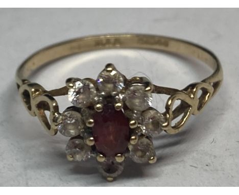 A 9 CARAT GOLD RING WITH A CENTRE RUBY SURROUNDED BY CUBIC ZIRCONIAS WITH HEART DESIGN SHOULDERS R SIZE  GROSS WEIGHT 1.61 GR