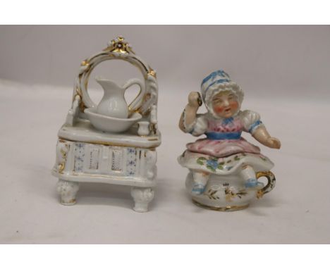 TWO ORIGINAL GERMAN CONTA AND BOHME TRINKET BOX FAIRINGS TO INCLUDE A DRESSING TABLE WITH WASH JUG AND BASIN AND GIRL IN A BO