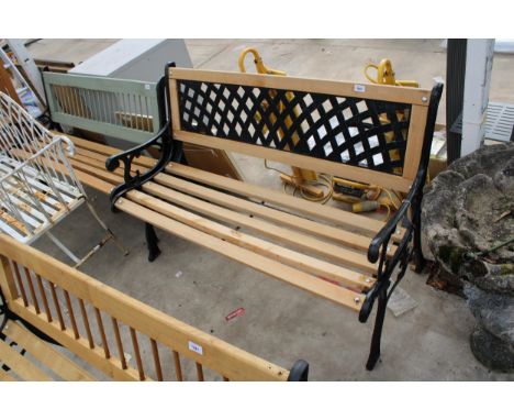 A WOODEN SLATTED GARDEN BENCH WITH CAST BENCH ENDS AND METAL LATTICE BACK 