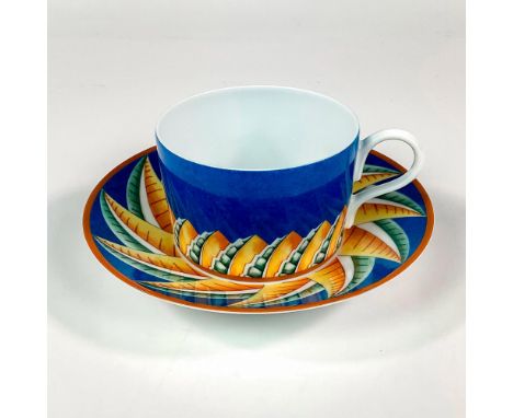 Discontinued pattern. Elegant and lightweight porcelain flat cup and saucer. Design features a cerulean blue ground with abst