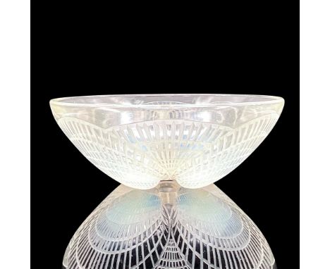 Striking crystal bowl in a seashell design with opalescent accents. R Lalique France mark. Dimensions: 3.5"H x 9.5"diaManufac