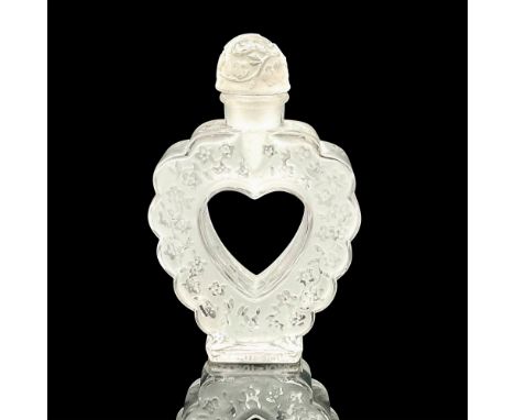 A vintage clear and frosted heart shaped perfume bottle adored with flowers, and a butterfly on the stopper. Coeur Joie Nina 
